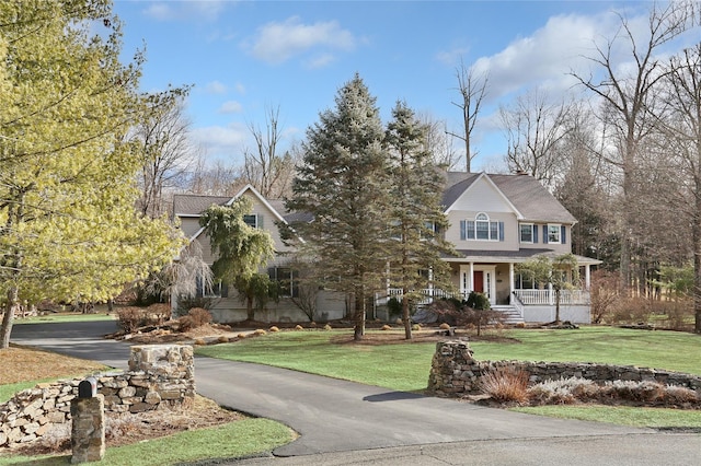 view of front of home with a front yard and covered porch