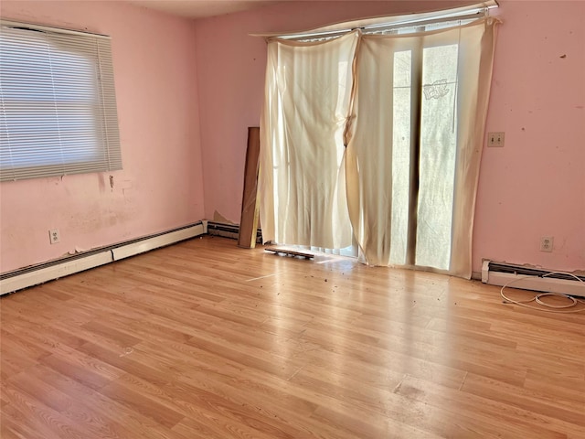 unfurnished room featuring light hardwood / wood-style flooring and a baseboard radiator