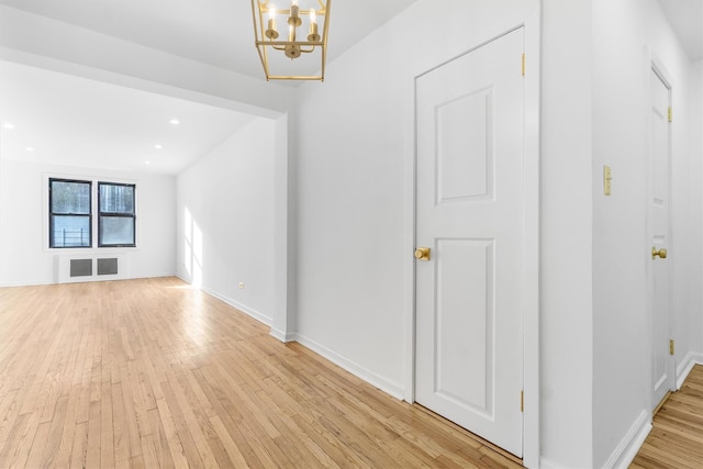 interior space featuring light wood-type flooring and a chandelier