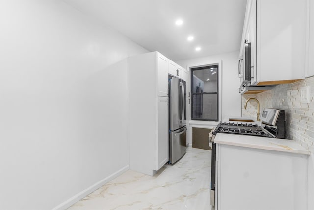 kitchen featuring tasteful backsplash, white cabinetry, and stainless steel appliances