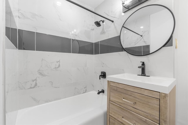 bathroom with vanity, decorative backsplash, tiled shower / bath combo, and tile walls