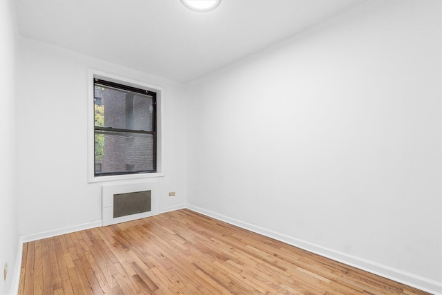 empty room with hardwood / wood-style floors