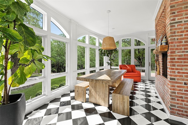 sunroom / solarium featuring a healthy amount of sunlight