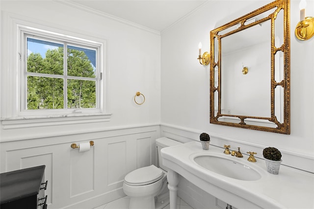 bathroom with toilet, crown molding, sink, and tile patterned flooring