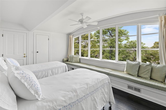 bedroom featuring dark hardwood / wood-style flooring, vaulted ceiling, and ceiling fan