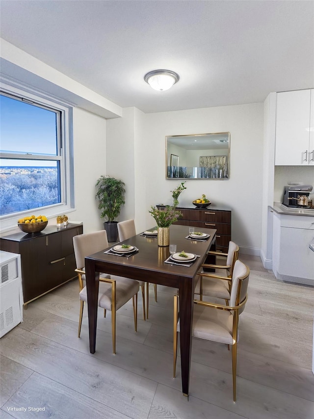 dining space with light hardwood / wood-style floors