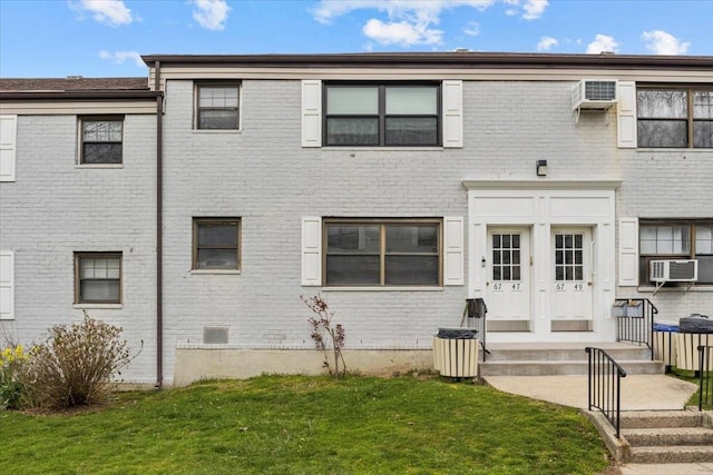 townhome / multi-family property with french doors, a wall mounted air conditioner, cooling unit, and a front yard