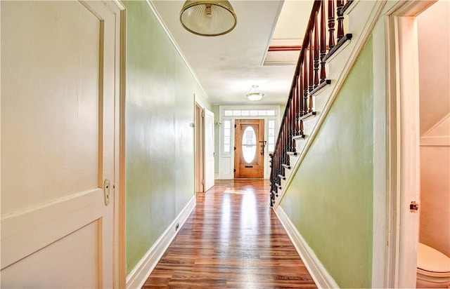 interior space with hardwood / wood-style flooring and ornamental molding