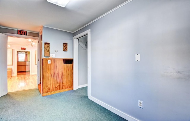 spare room featuring wood-type flooring and crown molding