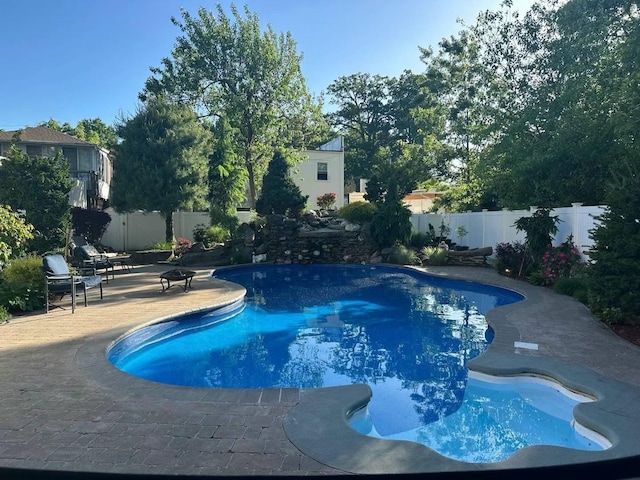 view of pool featuring a patio area and a fire pit