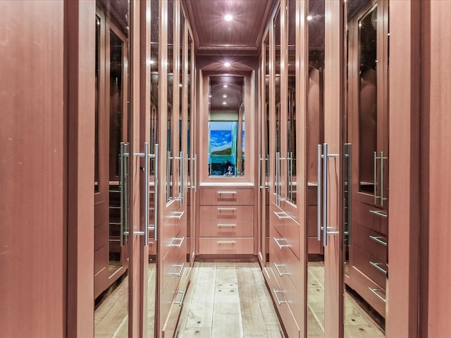 hallway featuring elevator and light hardwood / wood-style flooring