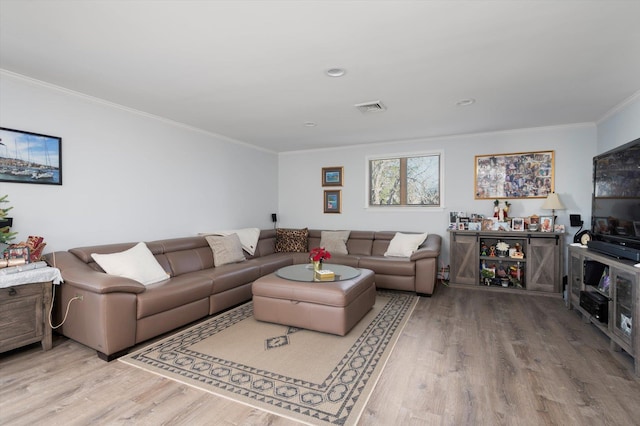 living room featuring light hardwood / wood-style flooring and ornamental molding