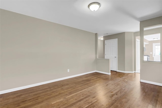 empty room with dark hardwood / wood-style flooring