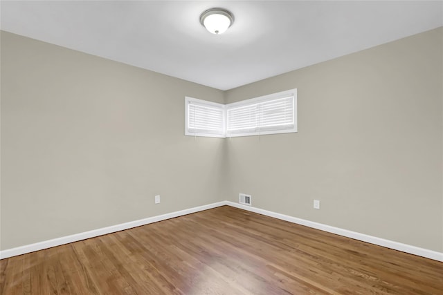 unfurnished room featuring hardwood / wood-style flooring