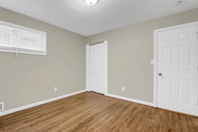 unfurnished bedroom featuring hardwood / wood-style flooring