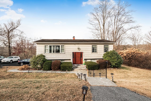 raised ranch with a front lawn