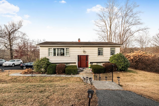 bi-level home with a front yard