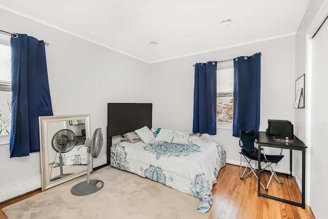 bedroom featuring wood-type flooring and ornamental molding