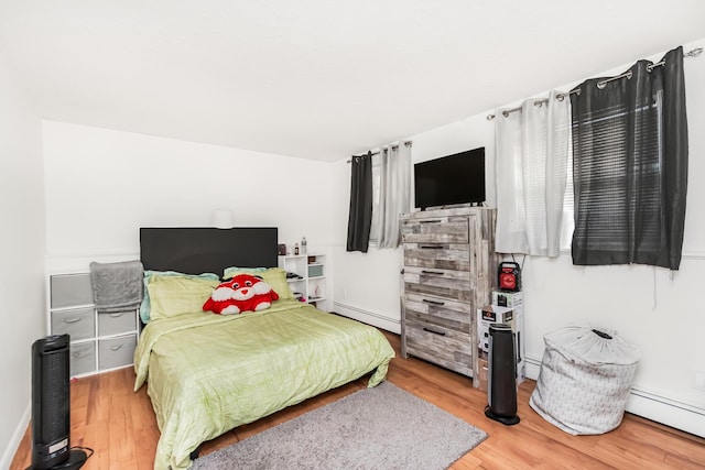 bedroom featuring light hardwood / wood-style flooring and a baseboard radiator