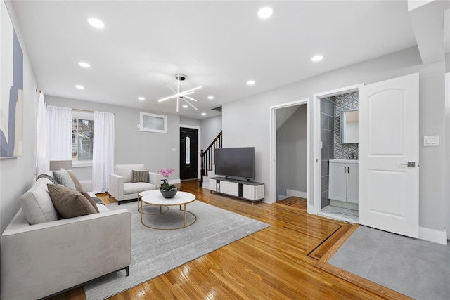 living room with wood-type flooring and a chandelier