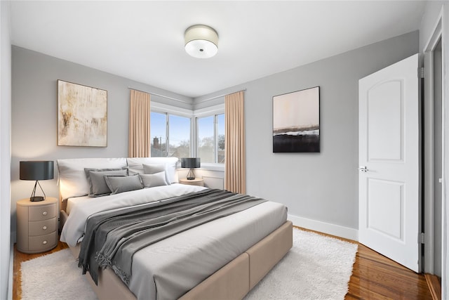 bedroom with hardwood / wood-style flooring