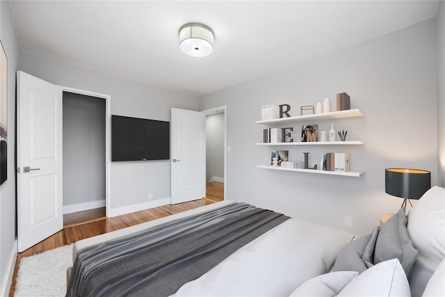 bedroom with hardwood / wood-style flooring