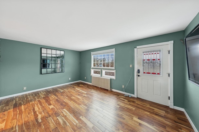 foyer featuring radiator heating unit and hardwood / wood-style flooring