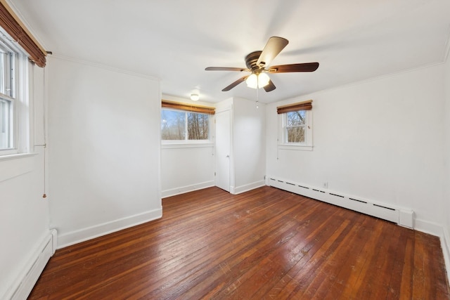 spare room with crown molding, ceiling fan, dark wood-type flooring, and a baseboard radiator