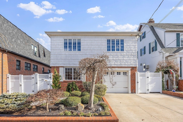 view of front of house with a wall mounted AC and a garage