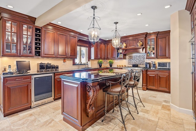 kitchen with pendant lighting, a center island, high end stainless steel range oven, wine cooler, and decorative backsplash