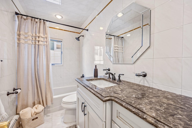 full bathroom with vanity, baseboard heating, shower / bath combo with shower curtain, tile walls, and toilet