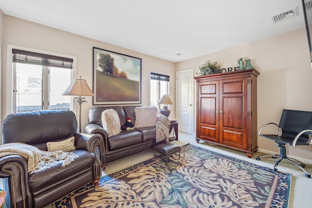 living room with a healthy amount of sunlight and light carpet