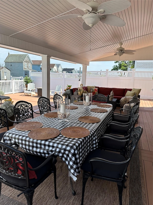 wooden deck featuring ceiling fan and an outdoor living space