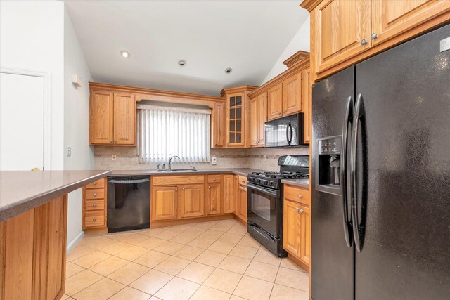20070 39th Ave, Bayside, NY 11361 - kitchen with black appliances, lofted ceiling, tasteful backsplash, light tile patterned floors, and a sink