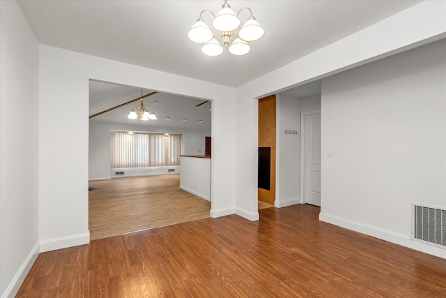 20070 39th Ave, Bayside, NY 11361 - unfurnished living room featuring a chandelier, wood finished floors, and baseboards