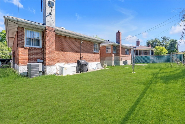 20070 39th Ave, Bayside, NY 11361 - rear view of property featuring a chimney, central AC unit, and brick siding