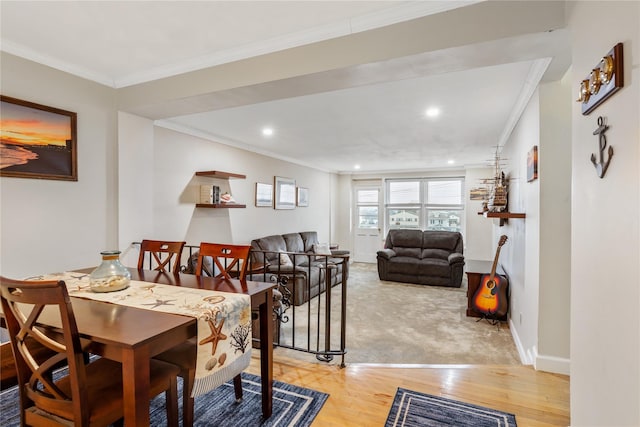 dining area featuring carpet flooring and crown molding