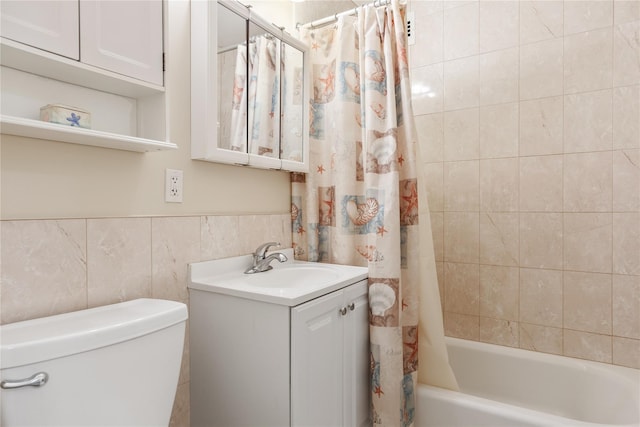 full bathroom with vanity, toilet, tile walls, and shower / tub combo with curtain