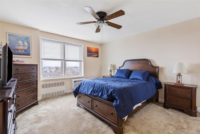 carpeted bedroom featuring ceiling fan, radiator heating unit, and a wall unit AC