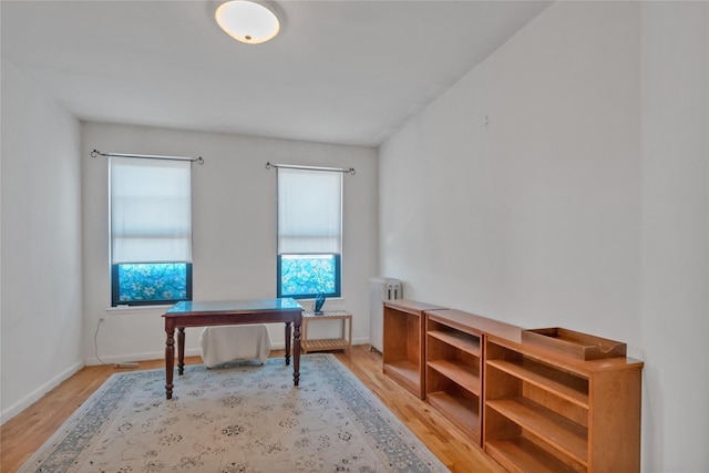 home office with light wood-type flooring and radiator