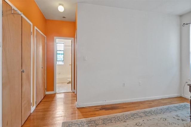 corridor with light hardwood / wood-style flooring