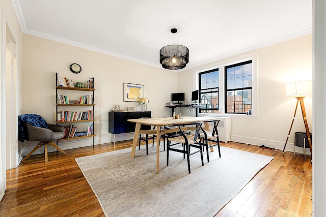 office space featuring hardwood / wood-style flooring, radiator, and crown molding