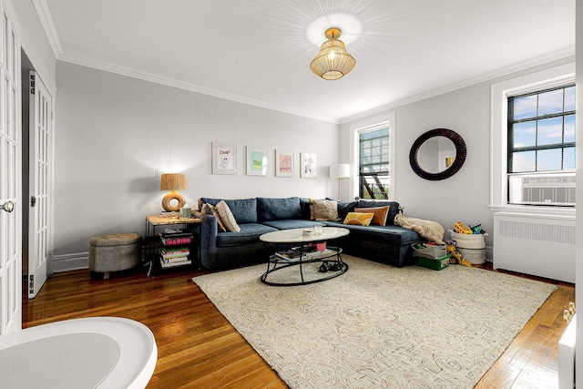 living room with radiator, dark hardwood / wood-style flooring, and ornamental molding