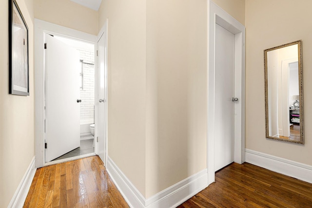 corridor with dark hardwood / wood-style floors