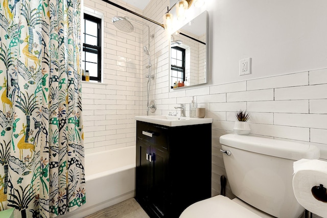 full bathroom featuring shower / bath combo, vanity, toilet, and tile walls