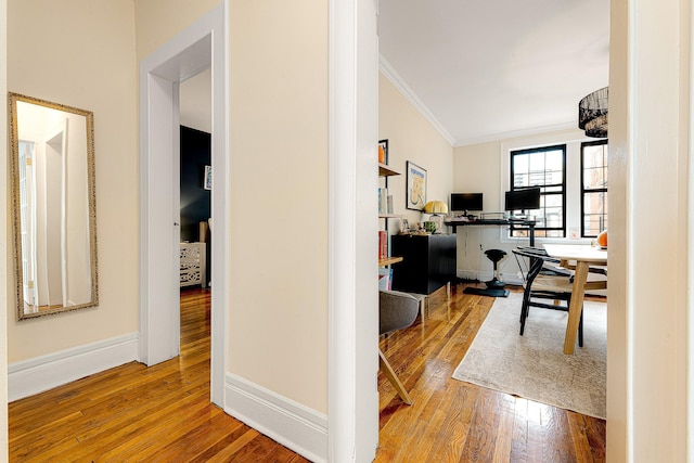 office area featuring wood-type flooring, ornamental molding, and an inviting chandelier