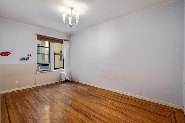 spare room with radiator heating unit, a notable chandelier, cooling unit, hardwood / wood-style flooring, and ornamental molding