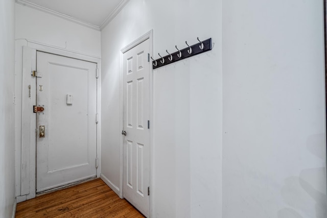 doorway to outside featuring hardwood / wood-style flooring and ornamental molding