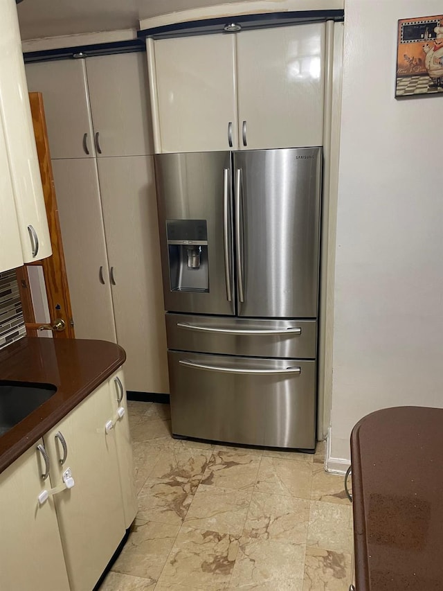 kitchen with white cabinets and stainless steel refrigerator with ice dispenser