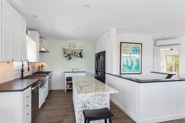 362 Ocean Walk, Fire Island Pines, NY 11782 - kitchen featuring freestanding refrigerator, a center island, dishwasher, dark wood-type flooring, and backsplash